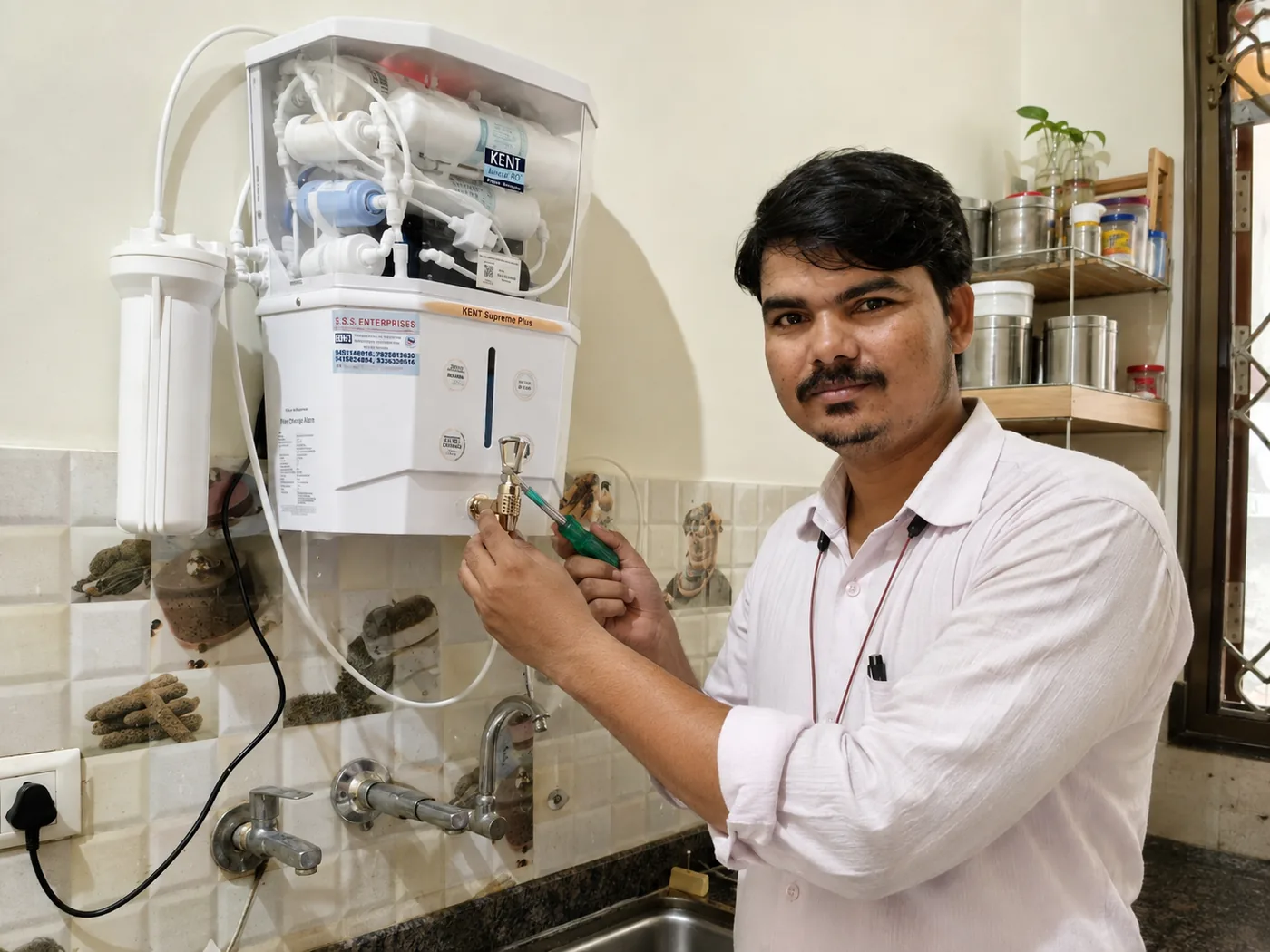 Our technician servicing a Kent RO water purifier in a customer's kitchen in Lucknow