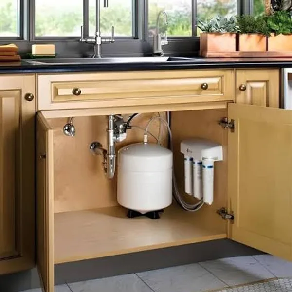 Under-sink RO water purifier with storage tank neatly installed inside a kitchen cabinet